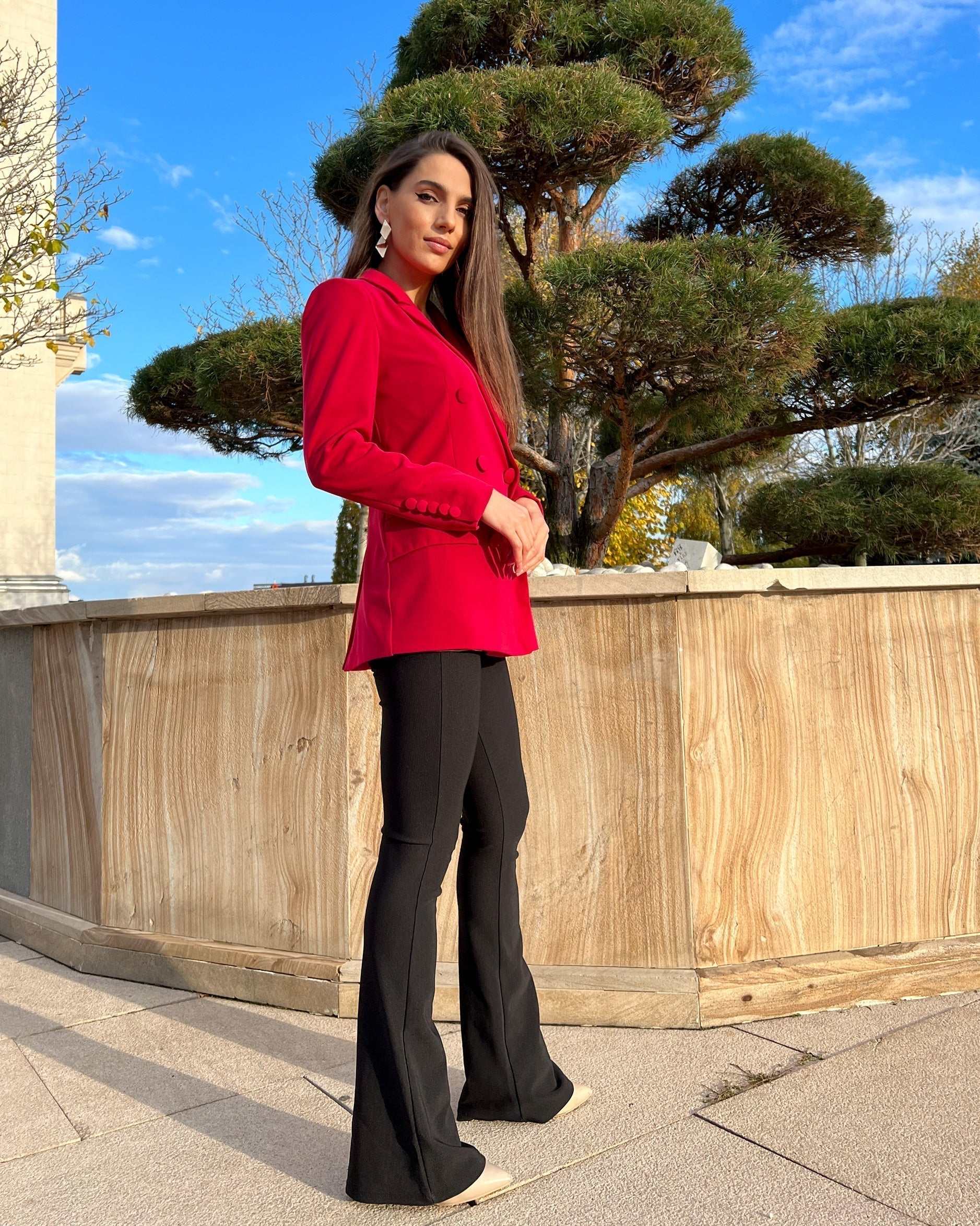 Sacou dama fucsia cu două rânduri de nasturi, model cambrat și lung, purtat afară.
